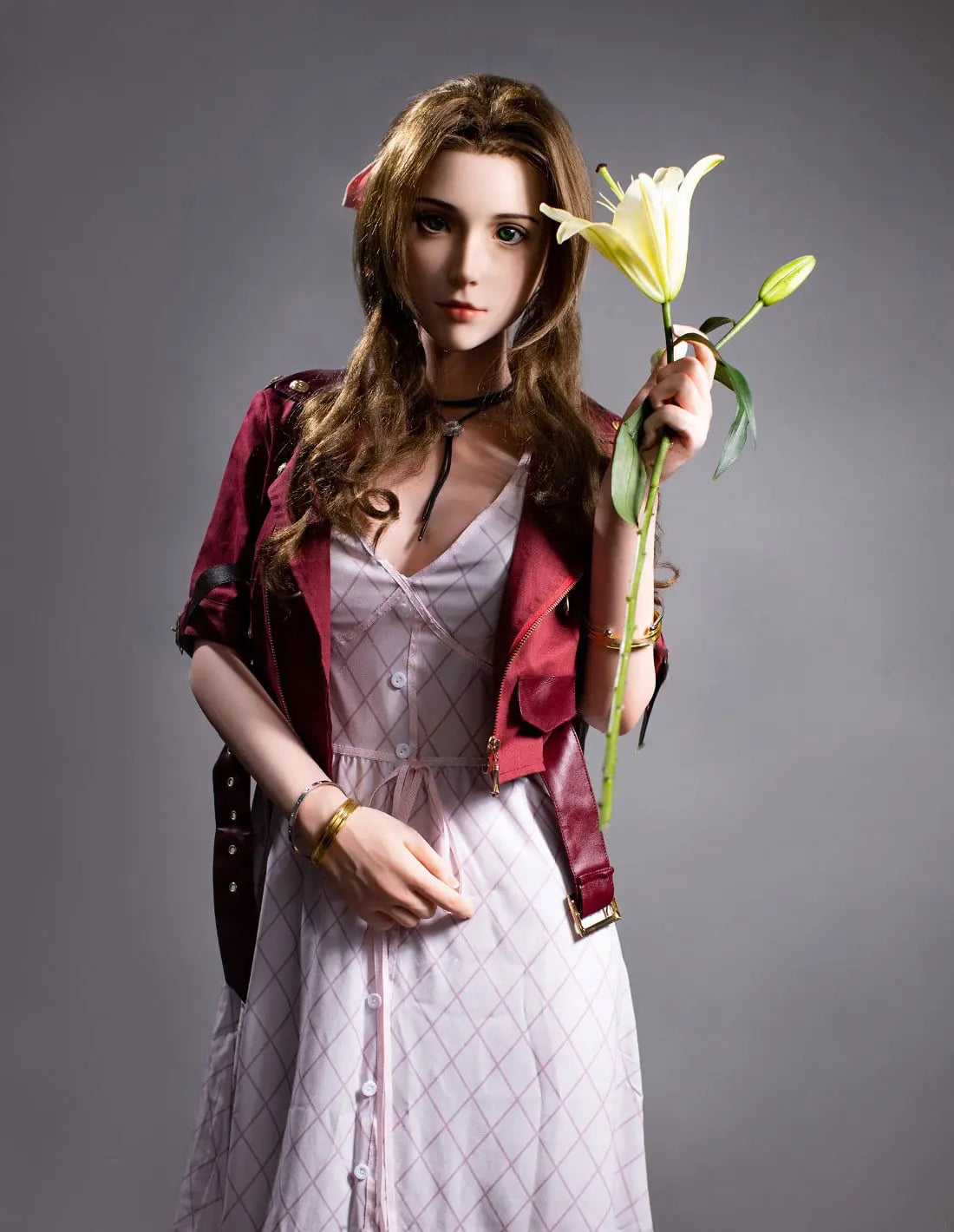 Hera full-size bookish sex doll with long dark brown curly hair and pink bow in dark red suede jacket and white lace dress, standing full body view with white lily flower prop, lifesize realistic adult doll by TopLoveDoll