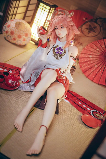  Yae Miko Genshin Impact cosplay sex doll, pink hair, sensual miko outfit, tatami room red cup – anime cosplay sex doll by TopLoveDoll,  red bell anklet, wooden geta sandals, Genshin Impact sex doll, sitting on the floor, holding a J-style red cup