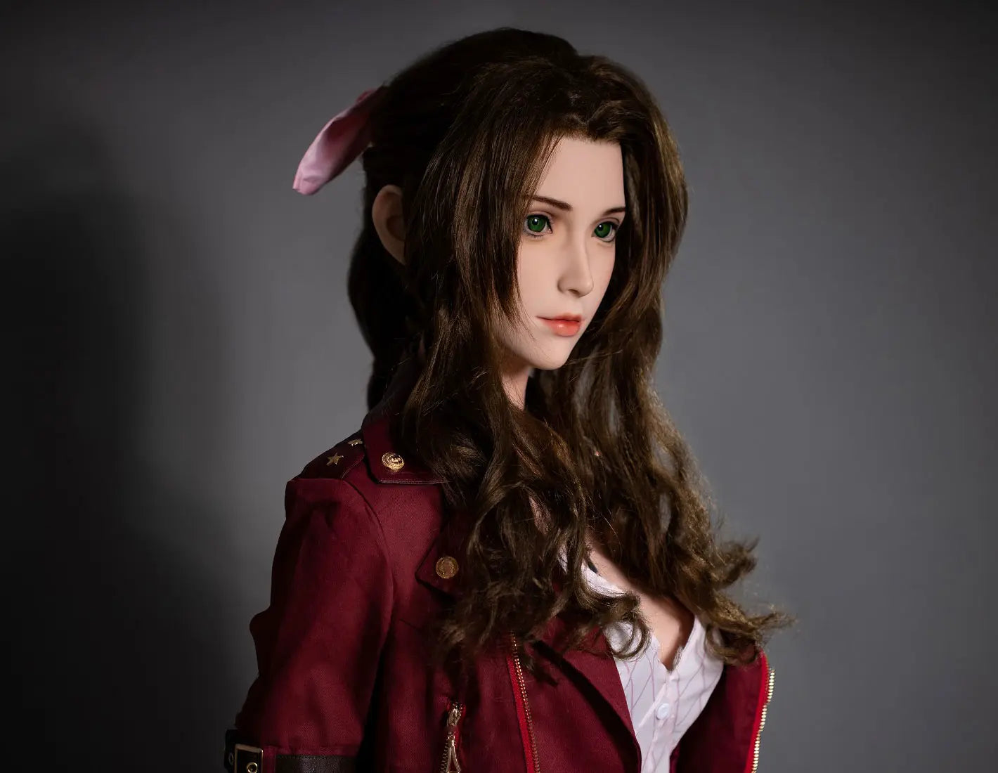 Hera, iconic green eyes, dark brown long curls hair, dark red suede jacket, white V-neck slip dress, pink bow, black choker, grey studio lighting background, chest-level shot, side view – European bookish bombshell companion sex doll by TopLovedoll