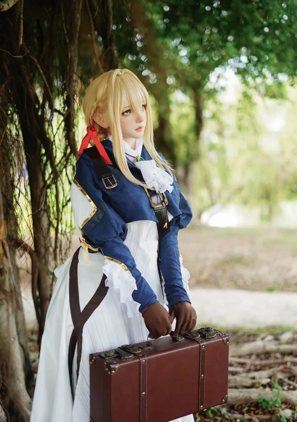 Aliana, golden straight long hair, blue eyes, navy Auto Memory Doll uniform, white apron, black leather boots, outdoor, green trees, standing, brown gloves, holding a brown leather suitcase, eye-level shot, bust shot, side view, a higher contrast filter – Violet Evergarden cosplay anime sex doll by TopLoveDoll