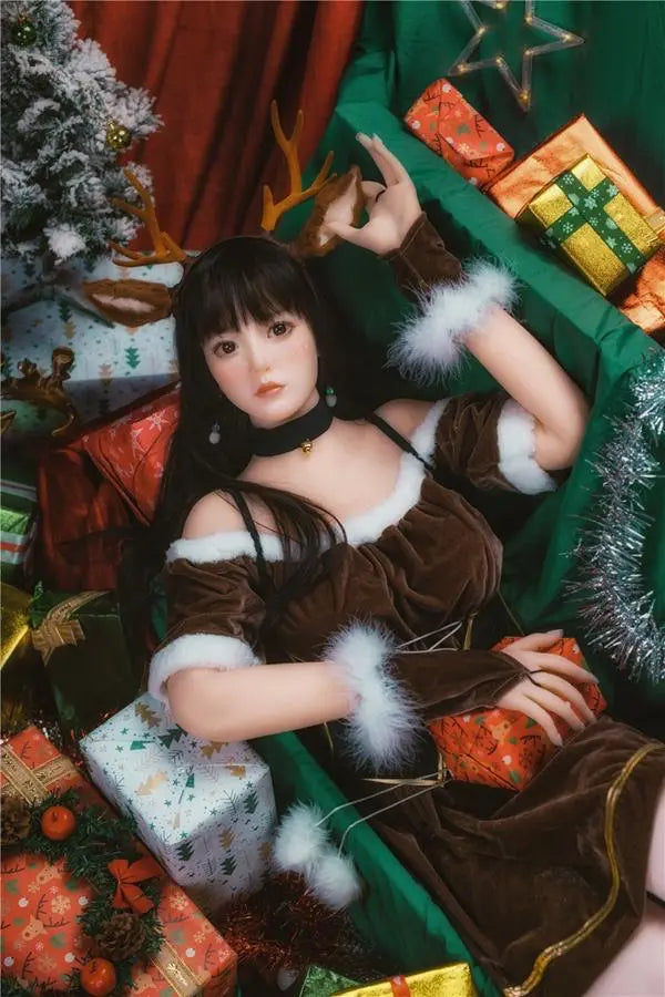 Amaris long black straight hair blunt bangs antler headband brown velvet top, Asian school goddess face Christmas red green background, cute asian girlfriend, lying among the gifts pile under Christmas tree, looking into the camera – deer girl cosplay sex doll by TopLoveDoll