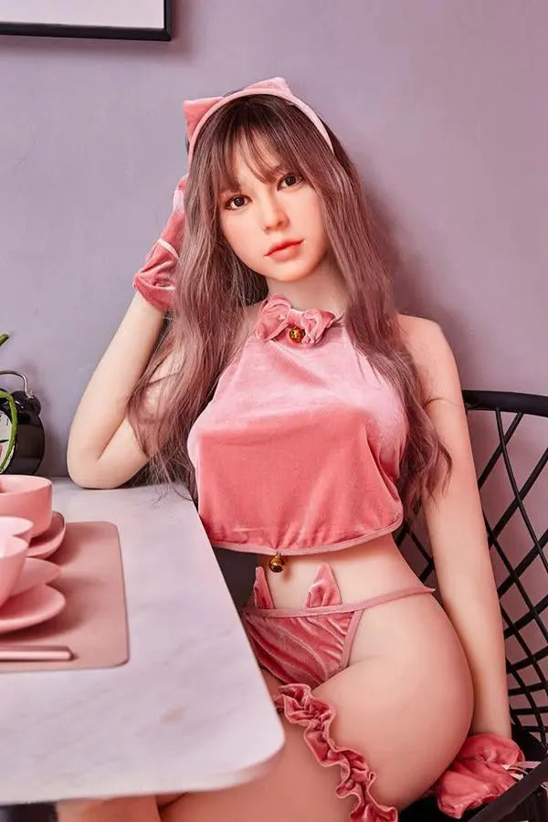 Amelia long wavy brown hair pink crop top pink mini skirt Y2K sweetgirl sitting in pink room soft Asian companion, sitting on a pink chair wearing pink lingerie set, sitting at the dinner table, waiting for her dessert – girl-next-door sex doll by TopLoveDoll