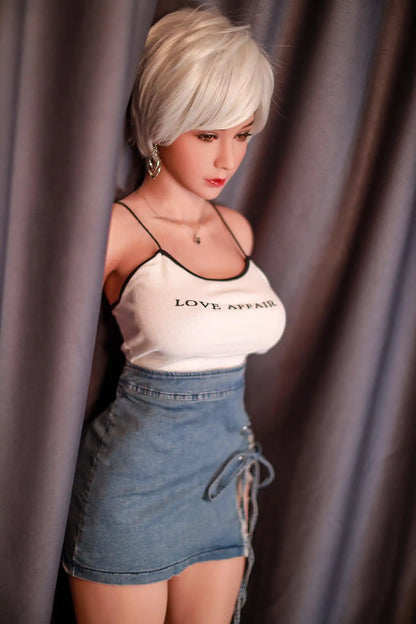 Anahi short platinum blonde hair tan skin white fitted tank denim micro skirt bold Shibuya street style pose, standing in front of the hotel curtain, side view – Asian blonde pornstar sex doll by TopLoveDoll