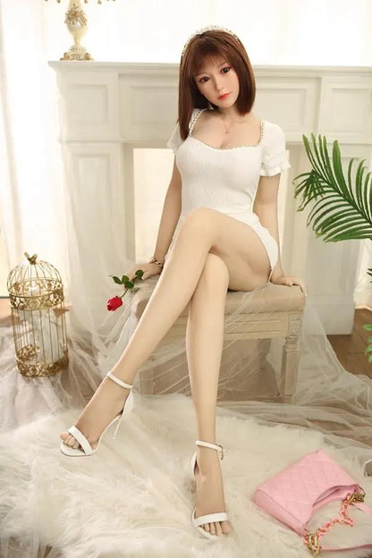 Anais natural soft waves white deep U-neck mini dress curvy sweet GND sitting pose, sitting on a chair– Asian girl-next-door sex doll by TopLoveDoll