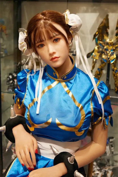 Araya Street Fighter Chun-Li cosplay sex doll, standing in front of her home figurine exhibits- blue qipao, high twin buns - Asian beauty elevated by TopLoveDoll