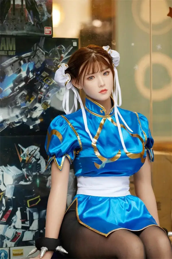 Araya Street Fighter Chun-Li cosplay sex doll, sitting in front of her Gundam collections, grey contacts, spiky bracelets, red nails- blue qipao, high twin buns, - Asian beauty elevated by TopLoveDoll