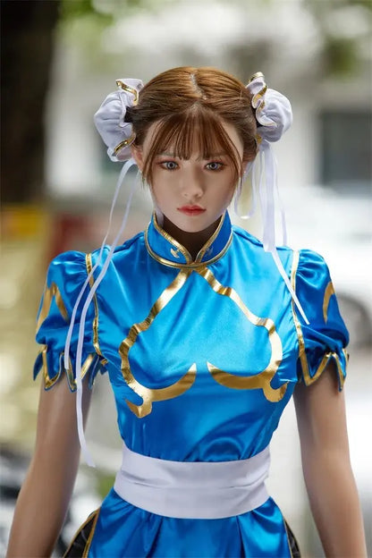 Araya Street Fighter Chun-Li cosplay sex doll, standing on a blurred park view background, grey contacts, spiky bracelets- blue qipao, high twin buns, - Asian beauty elevated by TopLoveDoll