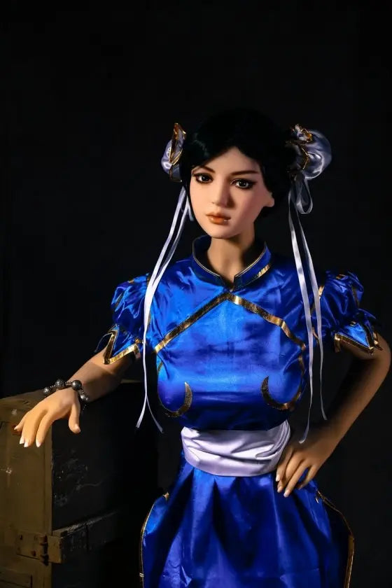 Aubriella Street Fighter Chun-Li cosplay sex doll in blue qipao on a black background, standing by some wooden boxes - iconic blue qipao fighter fantasy by TopLoveDoll