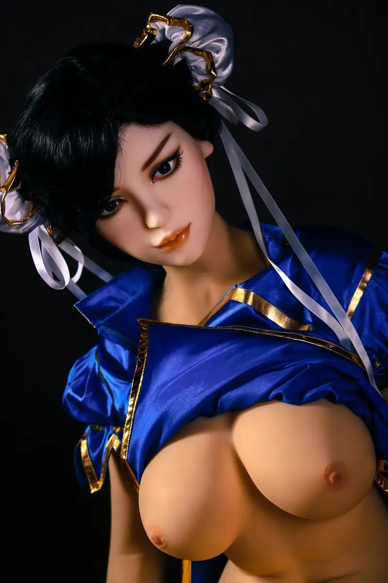 Aubriella Street Fighter Chun-Li cosplay sex doll in blue qipao on a black background, close up of the half naked sex doll, showing the side curves of her breasts, looking puzzled- iconic blue qipao fighter fantasy by TopLoveDoll