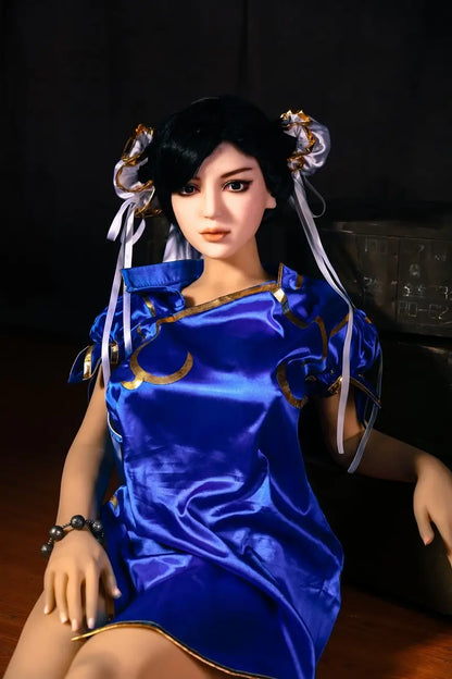 Aubriella Street Fighter Chun-Li cosplay sex doll in blue qipao on a black background, zippers of the dress was unzipped,  looking puzzled- iconic blue qipao fighter fantasy by TopLoveDoll