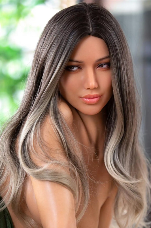 Viagra sex doll composed sidelong downward gaze with soft parted lips, warm brown eyes with sculpted brows, long wavy dark-root-to-ash-blonde ombre hair cascading over bare shoulder, ultra-realistic warm olive tan TPE skin with natural undertone, green bokeh outdoor background with soft natural daylight – bust close-up – lifelike mixed Latina sex doll by TopLoveDoll