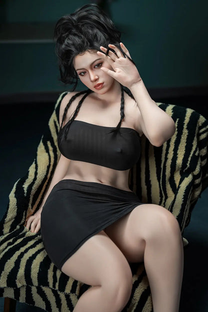 Lifelike Eastern Asian beauty with long black braided hair, wearing black tube top and skirt, sitting confidently on zebra-patterned throw – realistic companion doll at toplovedoll.com